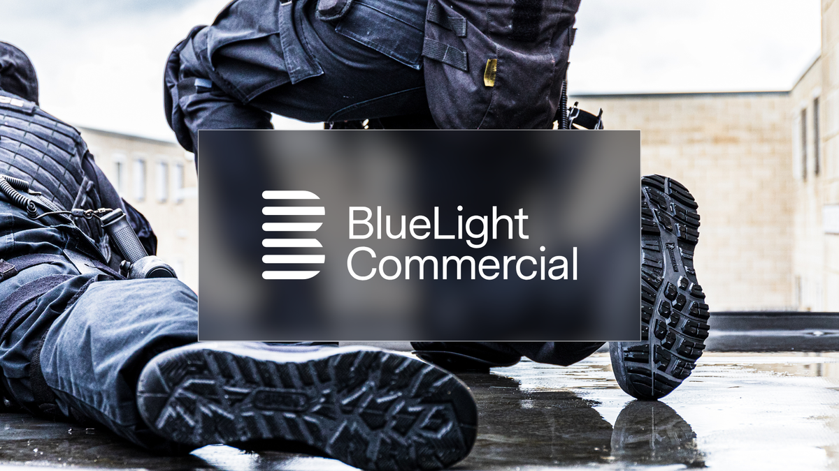 two police officers kneeling on the wet ground, camera view from behind with a focus on the footwear, overlayed with the BlueLight Commercial logo.