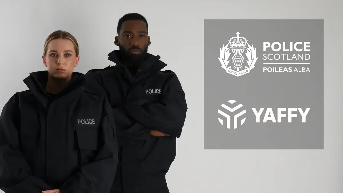 Two police officers wearing black protective suits face the camera, Police Scotland and Yaffy logo layered to the side. 
